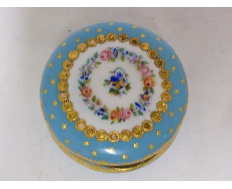 A French enamel box, decorated in Sevres style with concentric rings of summer flowers and tooled gilt jewels on a  blue Cele