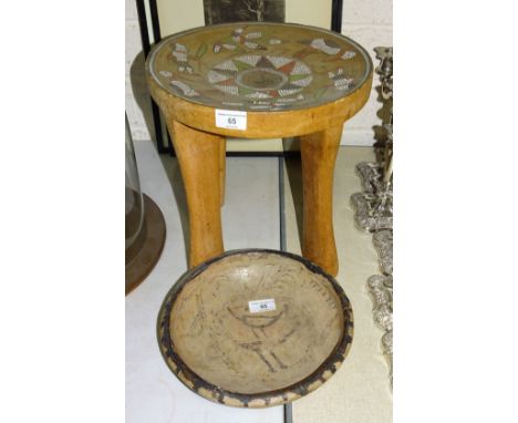 A 20th century Aboriginal wood tree trunk four-legged stool, the concave seat profusely-inlaid with bead work leaves, figures