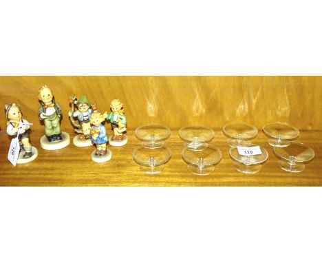 A collection of five Goebel Hummel figures: 'School Boy', 'Boy with horse', 'Girl with nosegay', 'Apple Tree Boy' and 'Solois