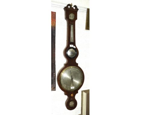 An early-19th century mahogany banjo barometer with silvered dry/damp, thermometer and barometer dials, having a central conv