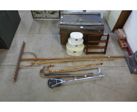 A vintage garden rake, tin trunk, small spice rack, walking canes, etc.