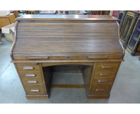 An early 20th Century oak tambour roll top desk, stamped The Lebus Desk
