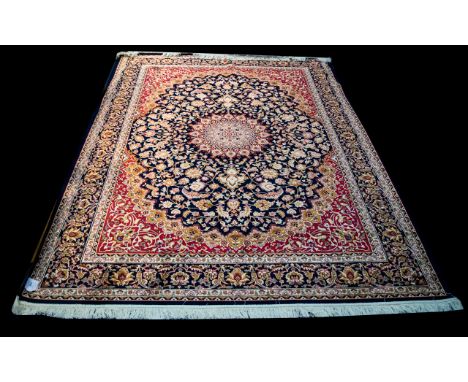 A Very Large Woven Silk Carpet Keshan rug with midnight blue ground and traditional Middle Eastern floral and foliate border 