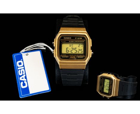 Casio Vintage Style Wristwatch Model Number F-91WM-9ADF. Water resistant, yellow gold tone face, black rubber strap. As new c