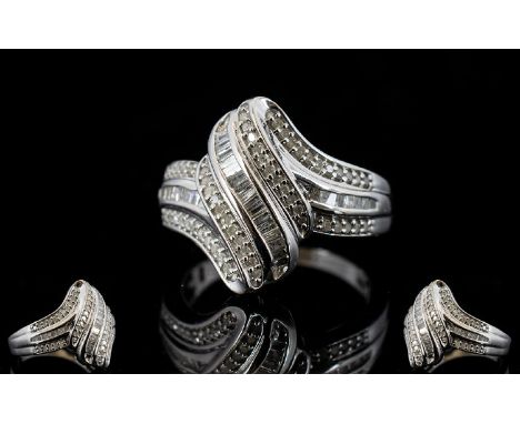 Diamond 'Wave' Ring, a row of baguette cut diamonds set between two rows of round cuts, totalling .5ct, swept in a wave forma