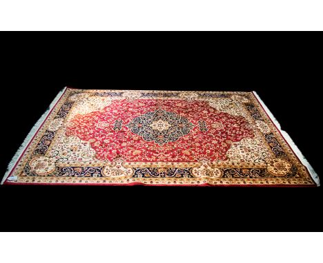 A Very Large Woven Silk Carpet Keshan rug with red ground and traditional Middle Eastern floral and foliate border detail wit