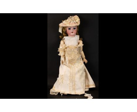 Bisque doll dressed in handmade clothes, 1890-1900