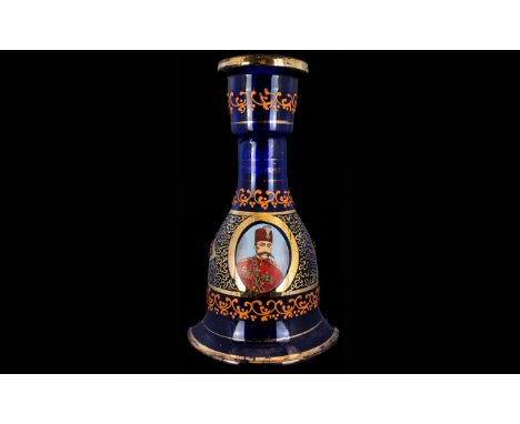 A Blue Glass Mallet Shaped Decanter With applied gilt decoration and portrait of Ottoman soldier to body. 10.5 inches high