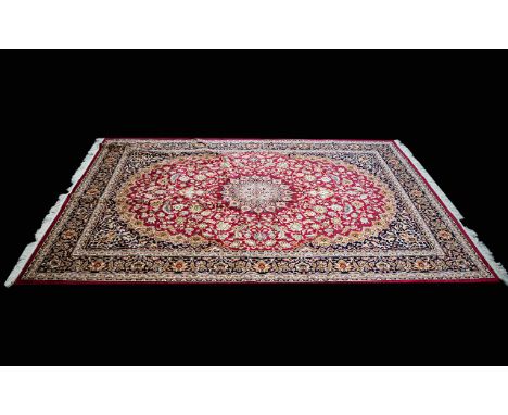 A Very Large Woven Silk Carpet Keshan rug with red ground and traditional Middle Eastern floral and foliate border detail wit