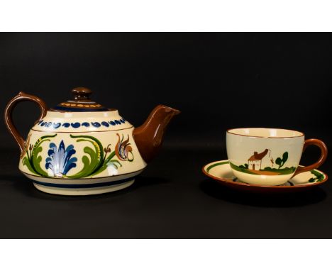 Oversized Cornish Slipware Teapot And Cup With Saucer A large teapot in traditional cream and brown glaze with blue floral ac