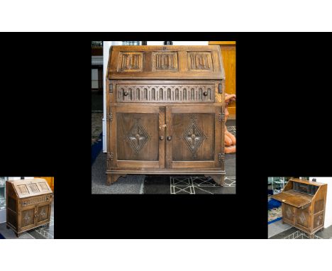 Oak Panelled Bureau of small proportions and typical form. Fall front with carved panel detail. Fitted interior above single 