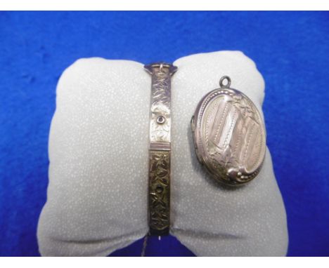 A 9CT FACED LOCKET AND A VICTORIAN 9CT GOLD BANGLE