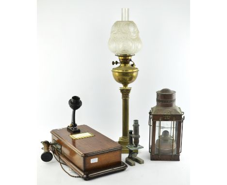 An early 20th century copper oil lantern, an early 20th century mahogany cased candlestick telephone, a brass students micros