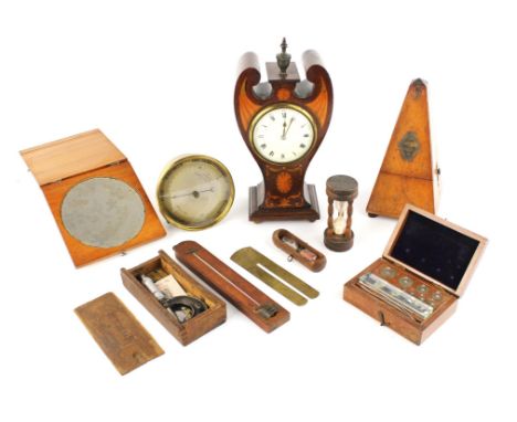 An Edwardian mahogany cased mantel clock of Art Nouveau form, 2905cm high, a mahogany cased Metronome by Melzel, 21.5cm high,
