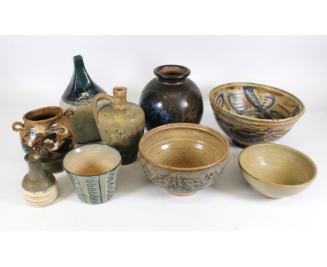 Greyshott Pottery, a globular stem vase, 11.5cm high, together with a twin handled pedestal vase, decorated with flours, 15.5