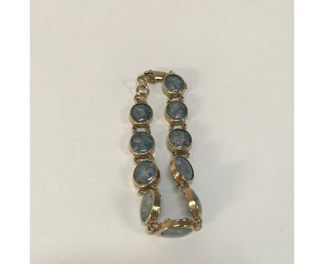 A decorative 9ct gold and opal mosaic bracelet