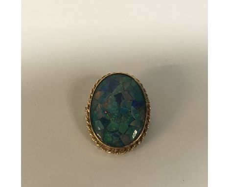 A 9ct gold oval opal mosaic pendant/brooch