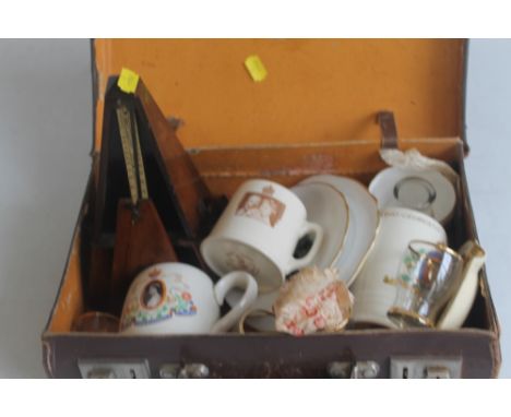 A WOOD CASED METRONOME, together with an old child's suitcase and a quantity of odds