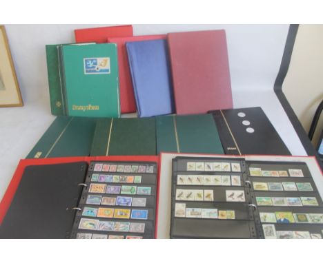 TWELVE ALBUMS OF WORLDWIDE STAMPS to include mint sets and first day covers