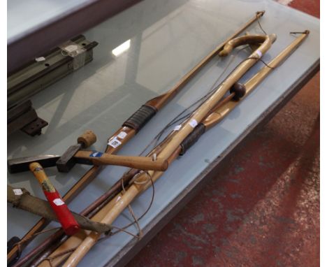A Shepherd's crook, a crofters antler tipped walking stick, two bow, three knives, an axe, and two hammers.  