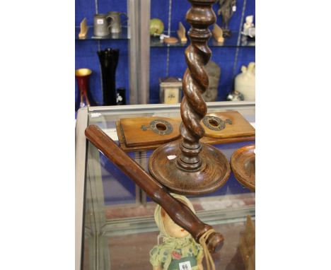 A vintage wooden truncheon, a pair of turned candlestick holders and a bookend 