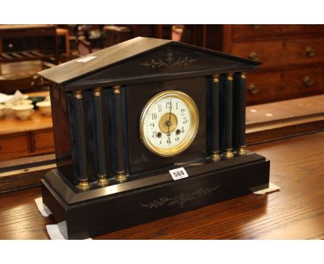 A French marble mantel clock with arched pediment, the dial flanked by columns on plinth 31cm high, 42cm wide 