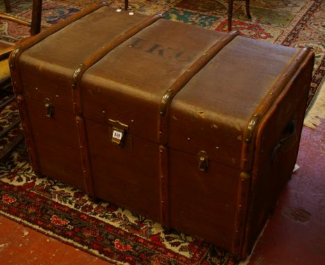 A vintage trunk with leather handles, bearing initials 'I.K.G' 90cm wide 