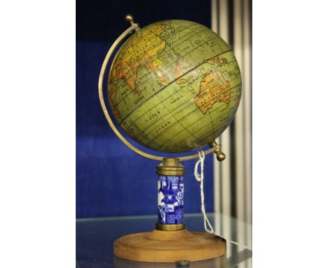 A painted metal globe with blue and white ceramic stem and wood base (af)Two reproduction military prints, one after Bastin, 