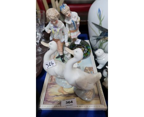 A lot comprising a pair of Nao figures of geese, a pair of continental porcelain figures of children with animals, a Milliefi