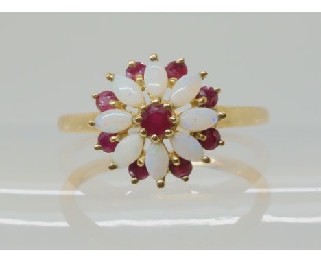 A 9ct gold opal and ruby flower ring, size N1/2, weight 2.4gms Condition Report: Available upon request