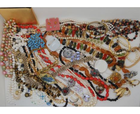 A collection of vintage costume jewellery to include beads, brooches etc Condition Report: Not available for this lot