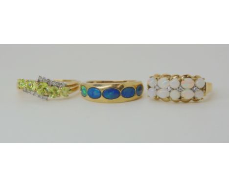 A 9ct gold peridot and diamond ring size O1/2, a white opal and diamond accent ring size O1/2, and a five stone black opal ri