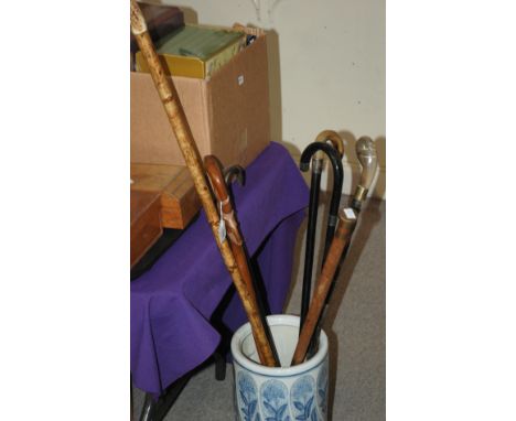 Ten various walking canes including a silver-topped ebony example and ceramic stick stand Condition Report: Available upon re