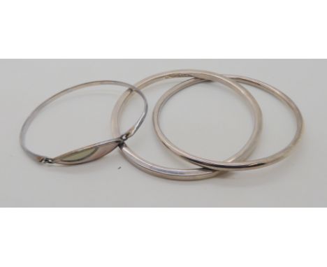 A double silver bangle by Ylang Ylang, and a mother of pearl inlaid bangle Condition Report: Not available for this lot