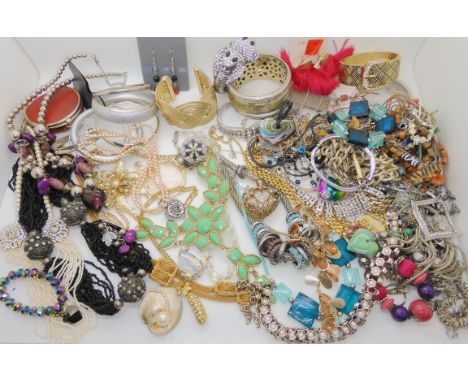 A costume jewellery cobra bangle, a vintage costume ring, a double string of pink freshwater pearls with a silver clasp, and 