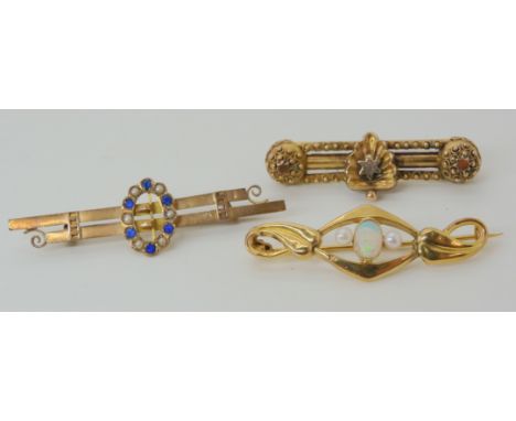 A 9ct opal and pearl Art Nouveau brooch, a Victorian Etruscan style 9ct brooch and a further blue gem and pearl buckle brooch