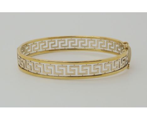 A 9ct gold Greek key pattern bangle, inner diameter 5.7cm, weight 15.6gms Condition Report: Inner diameter at widest point 5.