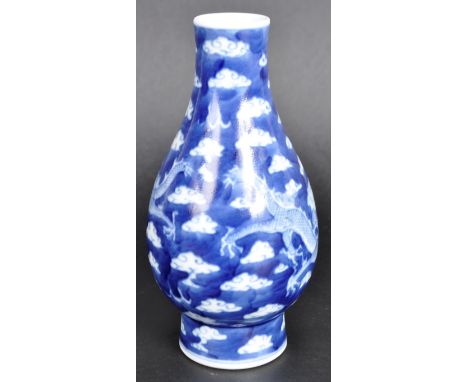 A 19th Century Chinese blue &amp; white porcelain vase having hand painted decoration depicting Dragons in clouds chasing the