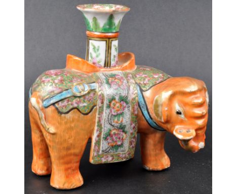 A 19th Century Chinese Famille Rose porcelain candlestick in the form of an Elephant. Central candle sconce with orange &amp;