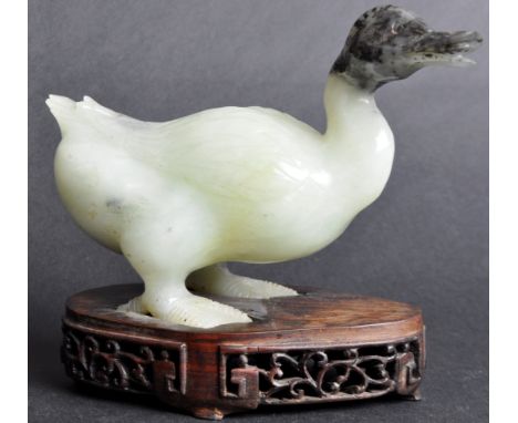 A 19th Century Chinese hand carved jade figurine depicting a Mandarin duck. The figure with blackened jade head and detailed 