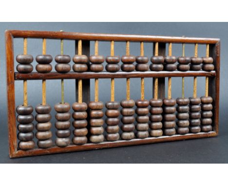 A Chinese Lotus Flower Brand wooden framed and turned abacus. Chinese Republic period with applied makers plaque. Traditional