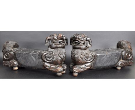 A large pair of 19th Century Chinese hand carved hardwood foo dogs / temple lions. Elongated form with carved facial features