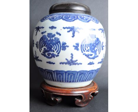 An 18th Century Chinese Kangxi blue and white porcelain temple jar / ginger jar. Carved wooden cover lid and socle base stand