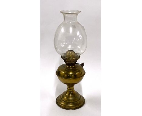 A brass oil lamp with glass chimney 