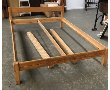 A king sized pine bed, the headboard 69cmH 