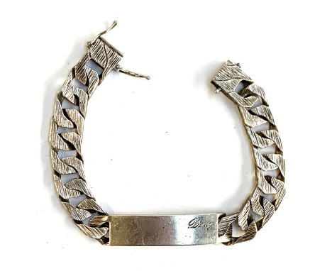 A heavy curb link bracelet with textured links, the tag engraved 'Doug', hallmarked for R Co., London, 1983, 22cm unclasped l
