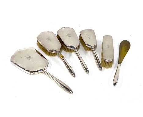 An early 20th century Japanese silver dressing table set, marked Okubo Sterling 998, comprising three graduating brushes, a c