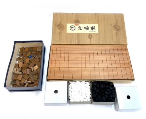 A Chinese Go board game with counters; together with bamboo mahjong pieces 