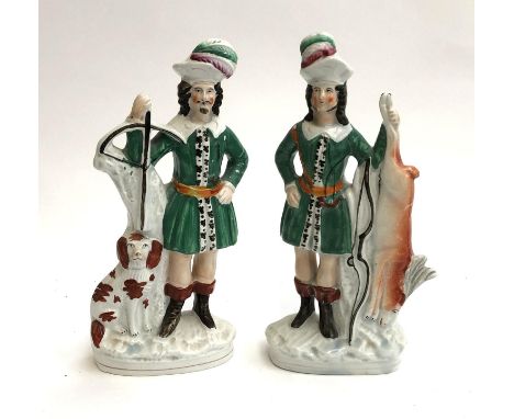 A pair of Staffordshire flatback figurines, 19th century, depicting hunter with spaniel and crossbow, and hunter with quarry,