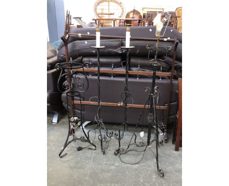 A pair of wrought iron standard lamps, 130cmH; a further wrought iron standard lamp; and a wrought iron pot stand 